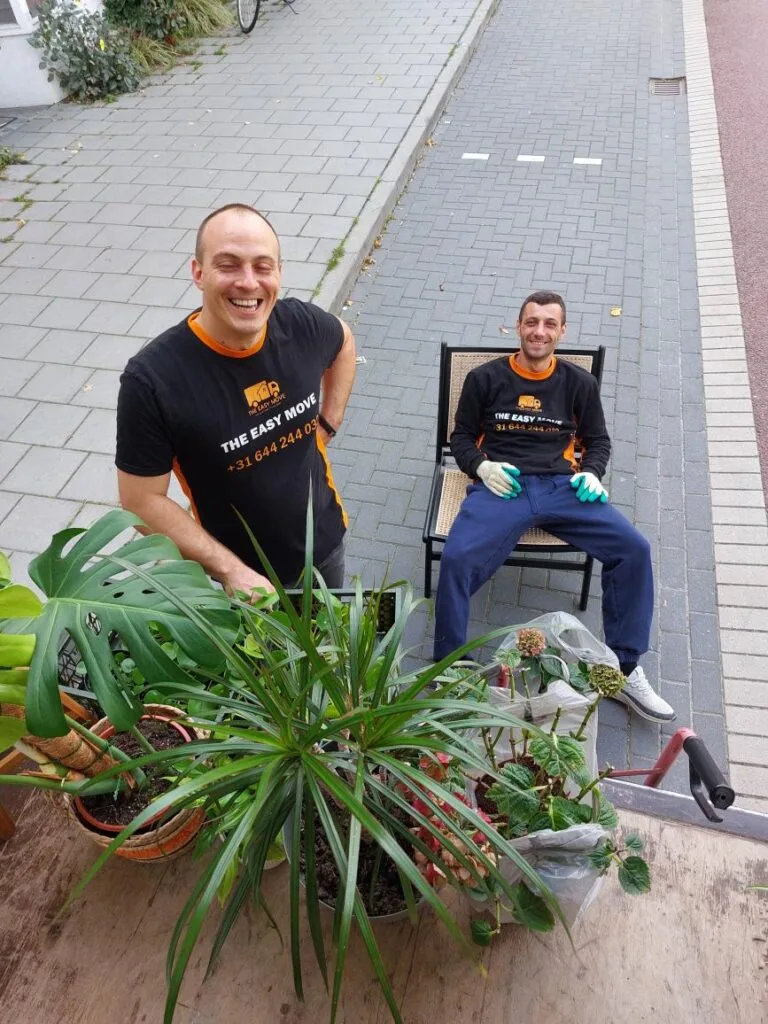 amsterdam moving van drivers at the back on the van, smiling